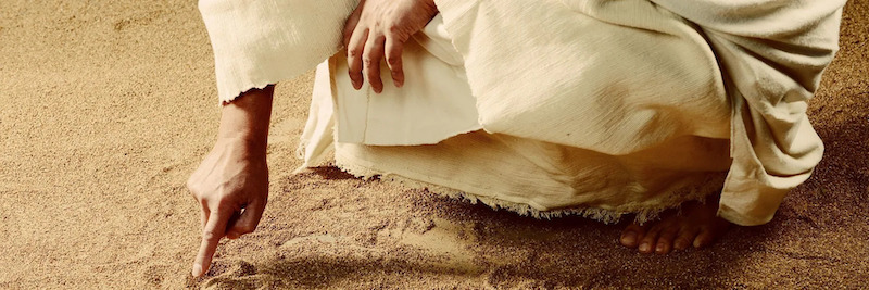 Jesus writes on ground